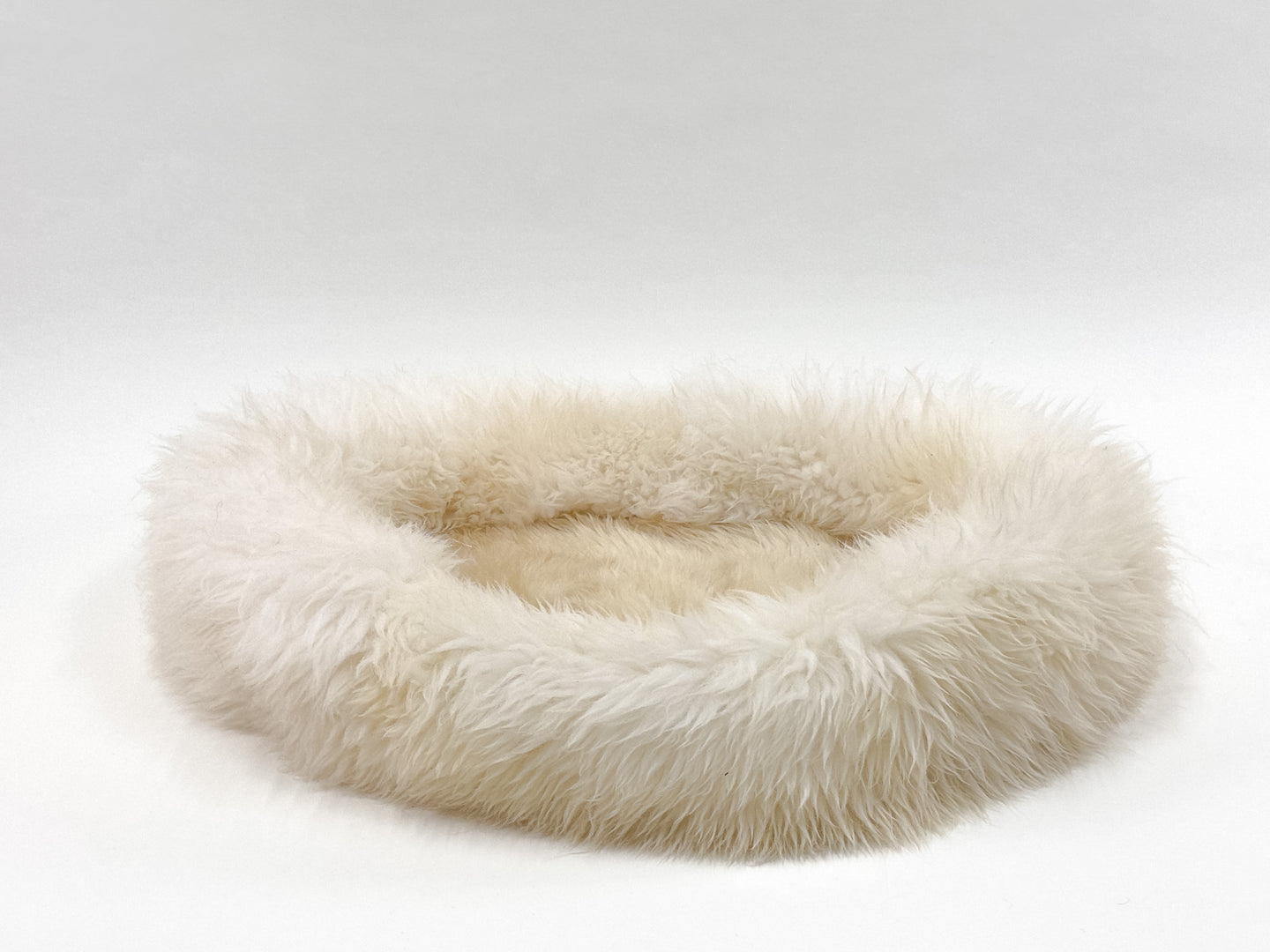 side view of sheep donut dog bed in creme