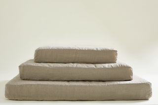 pile of 3 dog bed mattresses