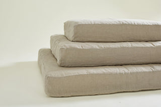 pile of 3 dog bed filling mattresses