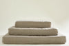 pile of 3 dog bed mattresses