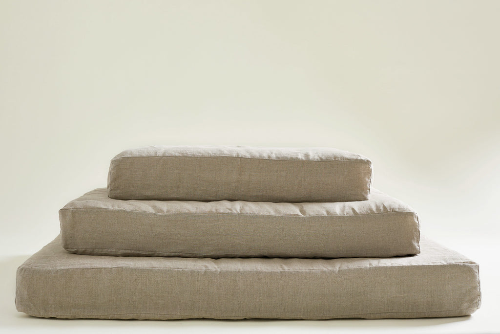 pile of 3 dog bed mattresses