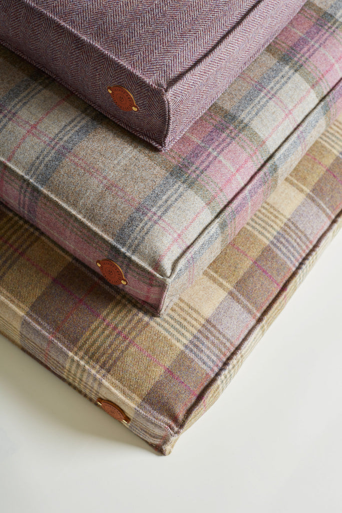 pile of 3 dog beds in colours Hollyhock, Bluebell and Blackberry