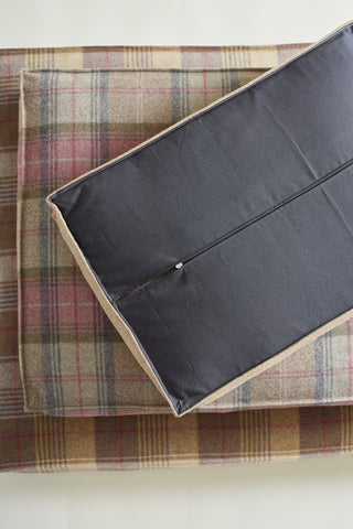 pile of 3 tweed beds and top one upside down showing the bottom with zipper